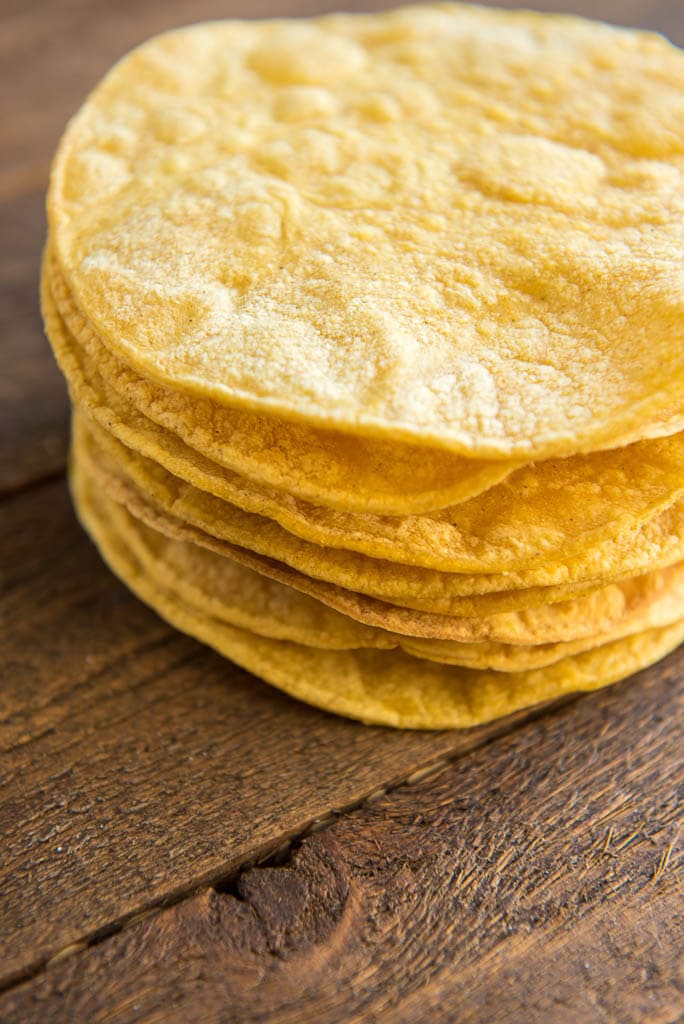 Baked corn tortillas in a stack for Crispy Chickpea Tostadas