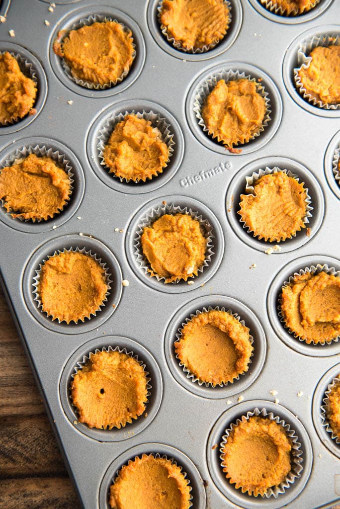 Mini muffin tin filled with Mini Pumpkin Pies ready for the oven.