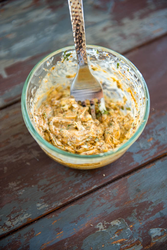 Butter whipped with seasonings in a glass bowl for Baked Lemon Butter Tilapia