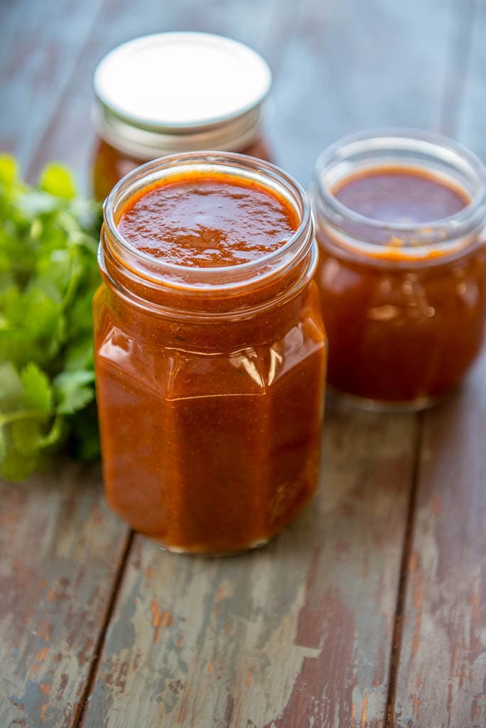 glass jars filled with homemade enchilada sauce