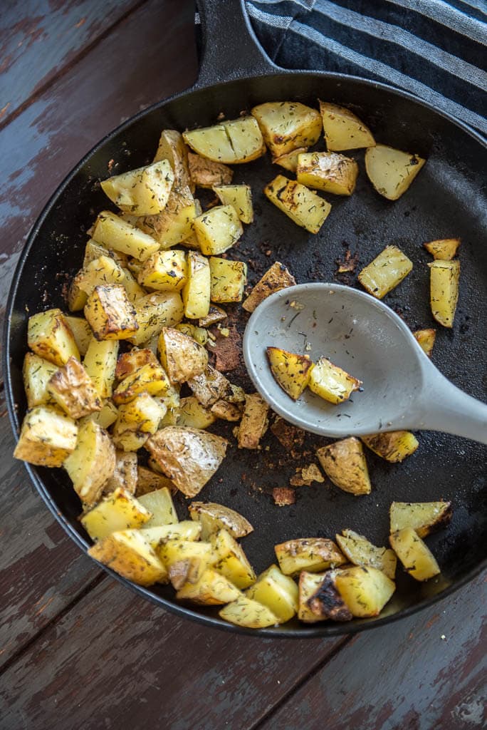 Easy Weekday Breakfast Potatoes in cast iron skillet on wooden table