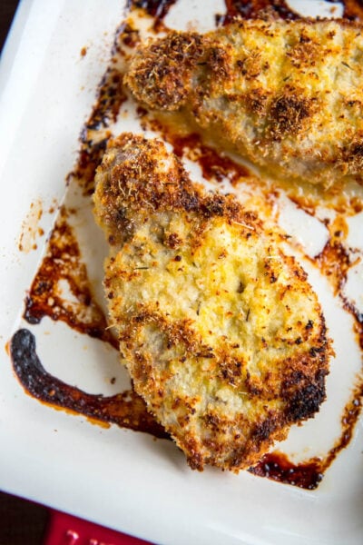 Parmesan Oven Baked Pork Chops in red and white casserole dish