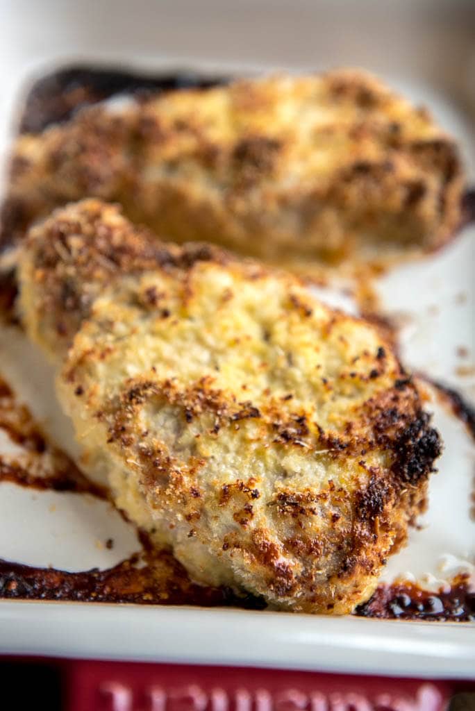 Parmesan Oven Baked Pork Chops in red and white casserole dish