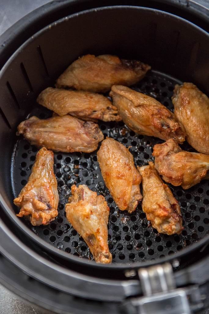 Air Fryer Chicken Wings cooked and cooling in air fryer basket