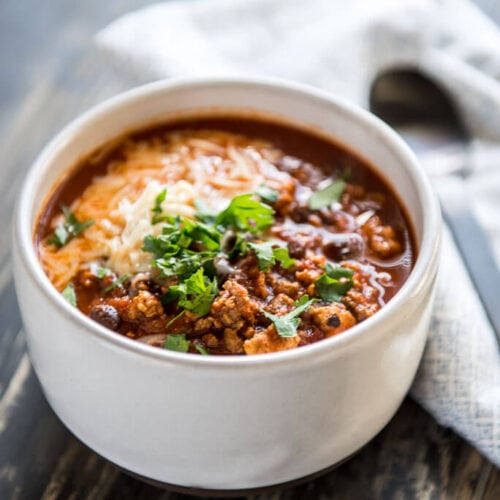 The Best IPA Beer Chili in a white bowl on a wood table