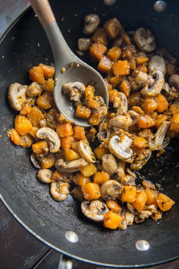 butternut squash and mushrooms in skillet as filling for vegan lasagna