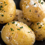 baked potatoes with salt and parsley in a large bowl