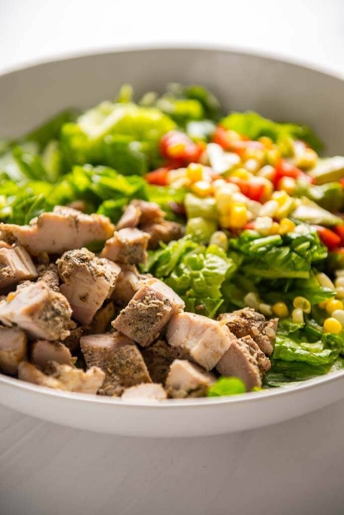 chopped grilled chicken thighs on a salad