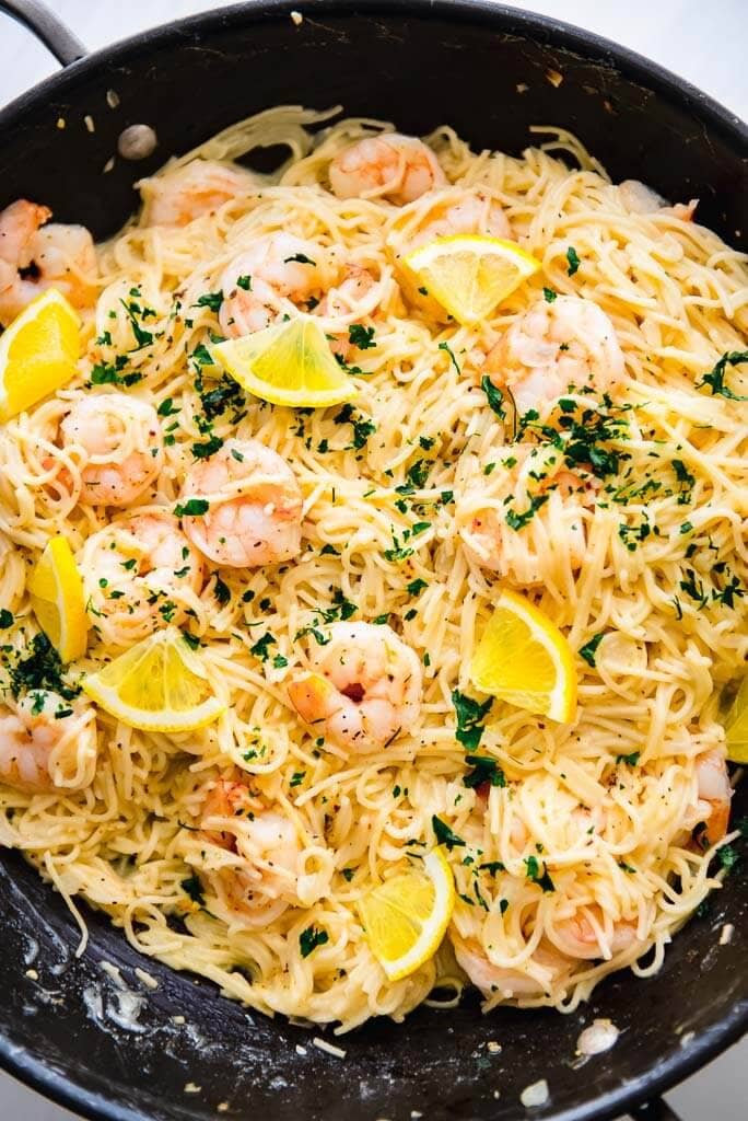 dark skillet full of lemon garlic shrimp pasta
