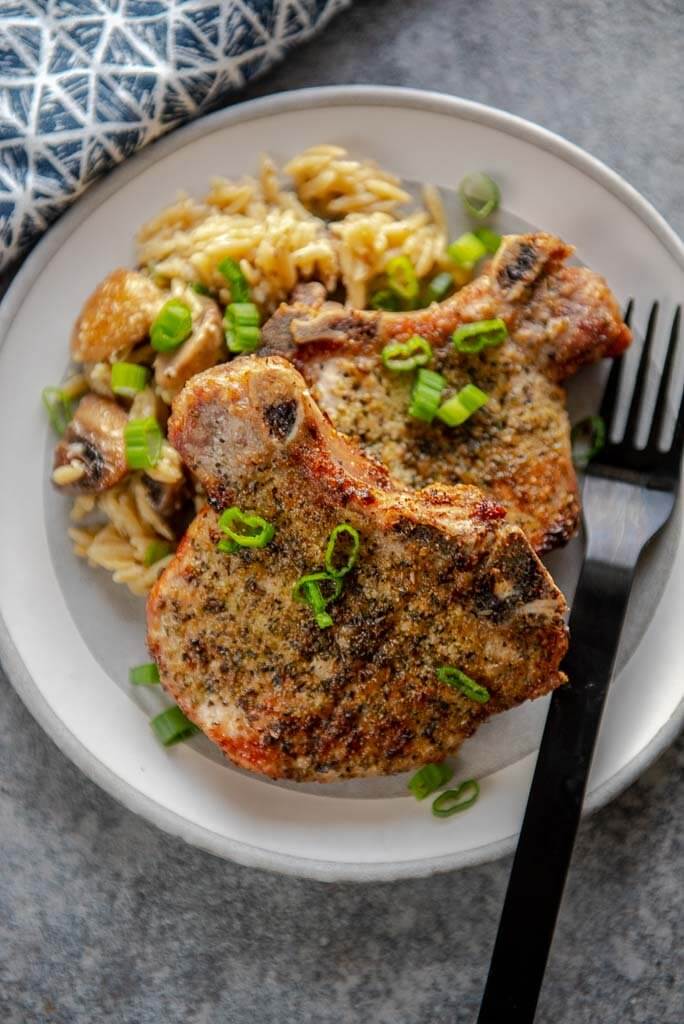 pork chops cooked in the air fryer on a white plate