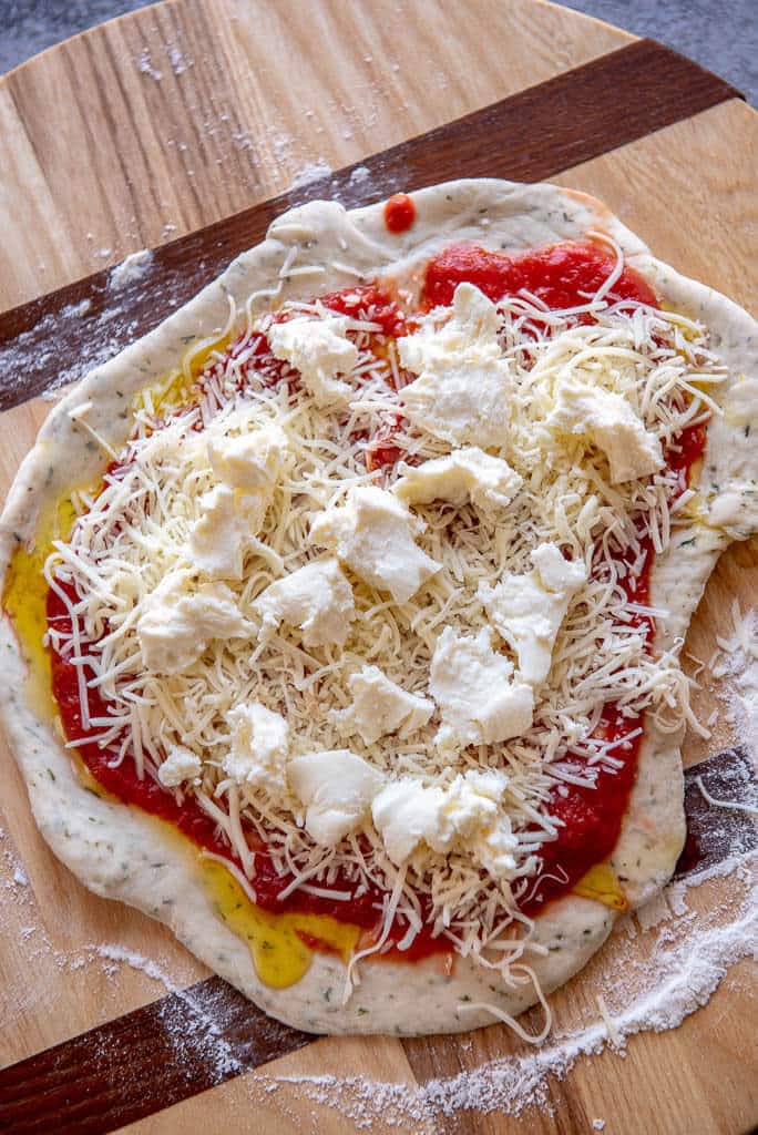 pizza crust topped with tomatoes and cheese