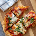 air fryer margherita pizza cut into 1/4 on wood board