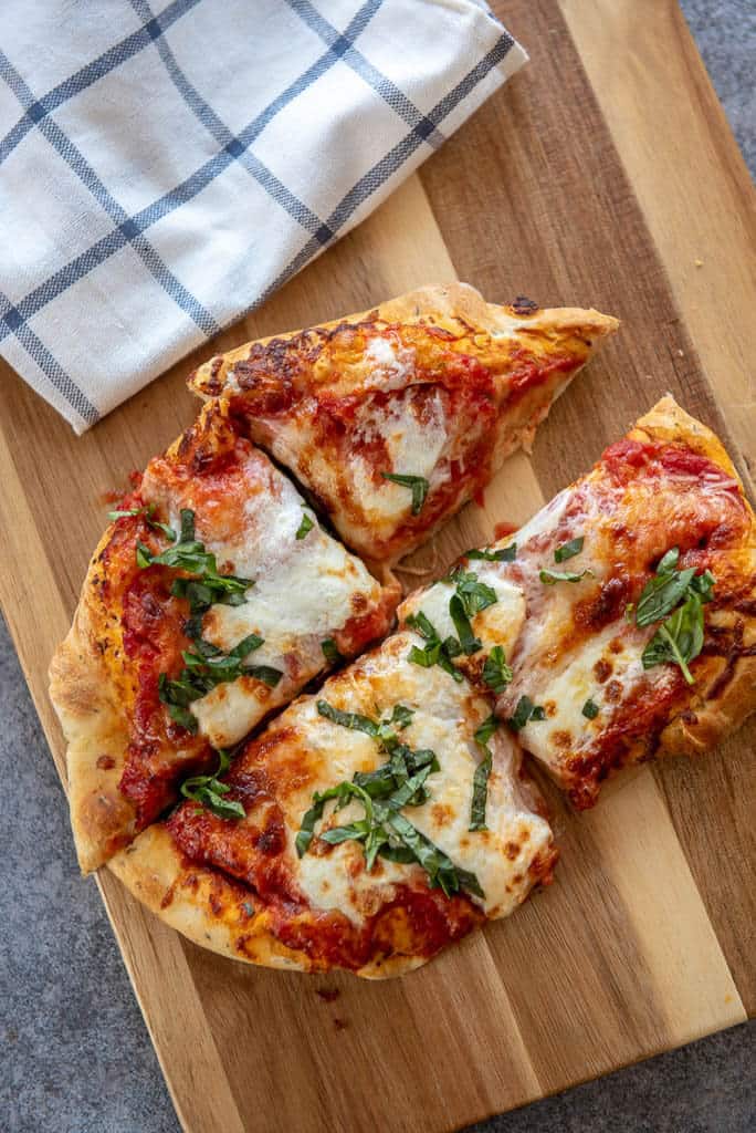 air fryer margherita pizza cut into 1/4 on wood board