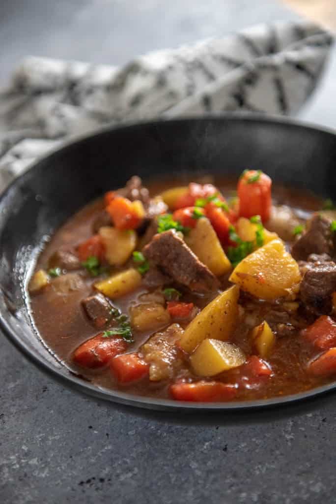 instant pot beef stew in black bowl
