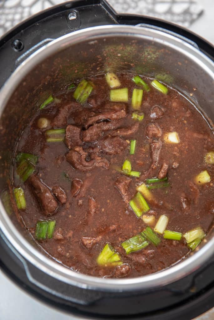 instant pot with cooked Mongolian beef with sauce