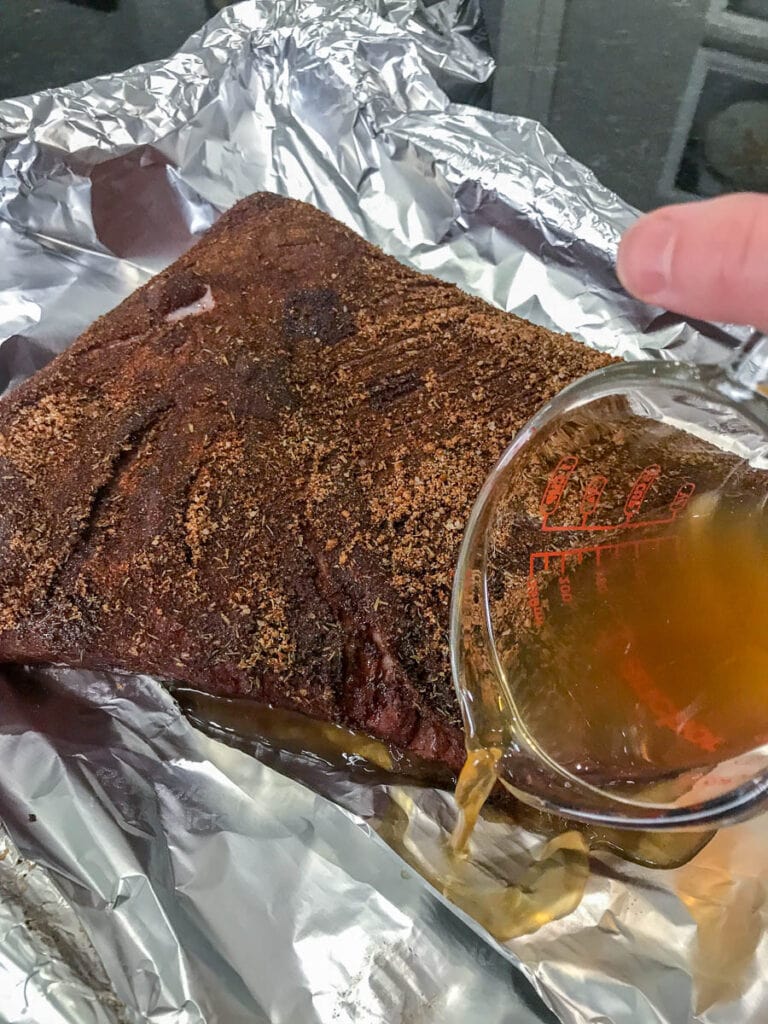 wrapping brisket in foil with broth