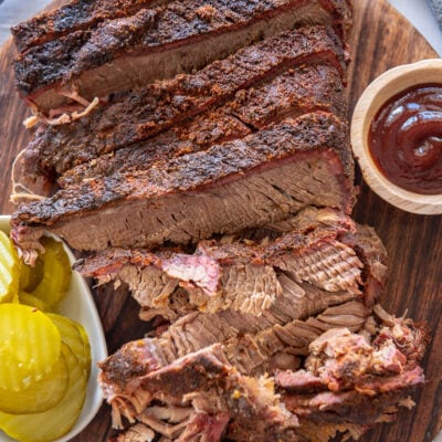 sliced brisket on round cutting board