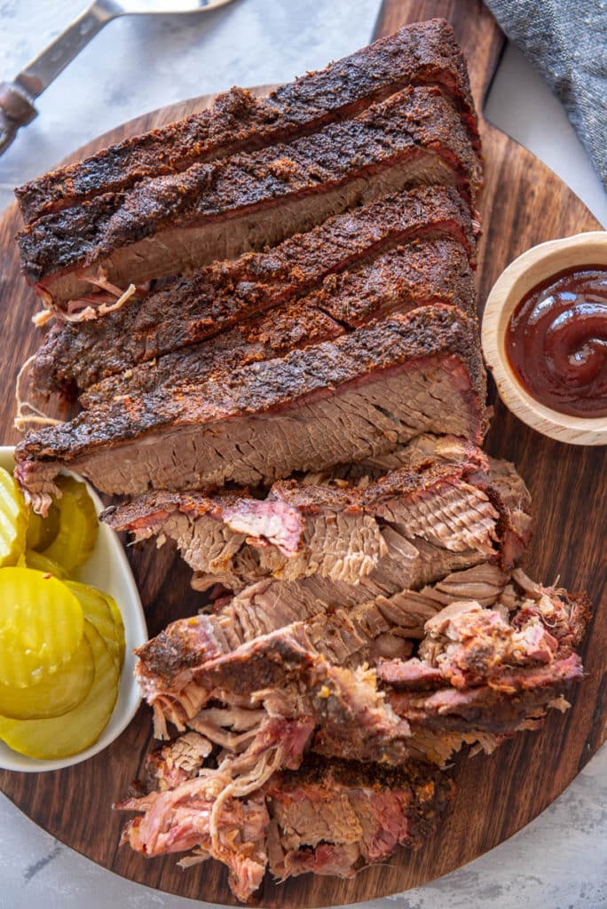 sliced brisket on round cutting board