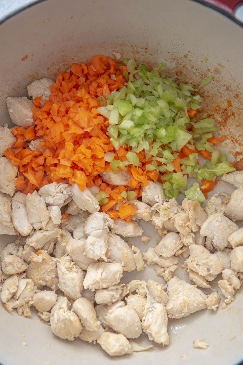 chicken with carrots and celery in dutch oven pan