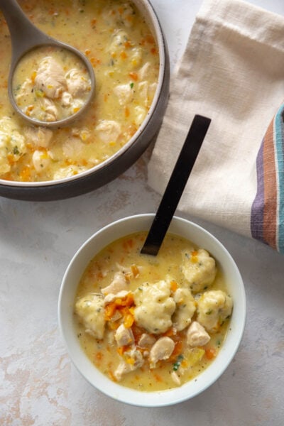 two bowls filled with chicken and dumplings