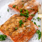 2 pieces of grilled salmon on white and blue plate