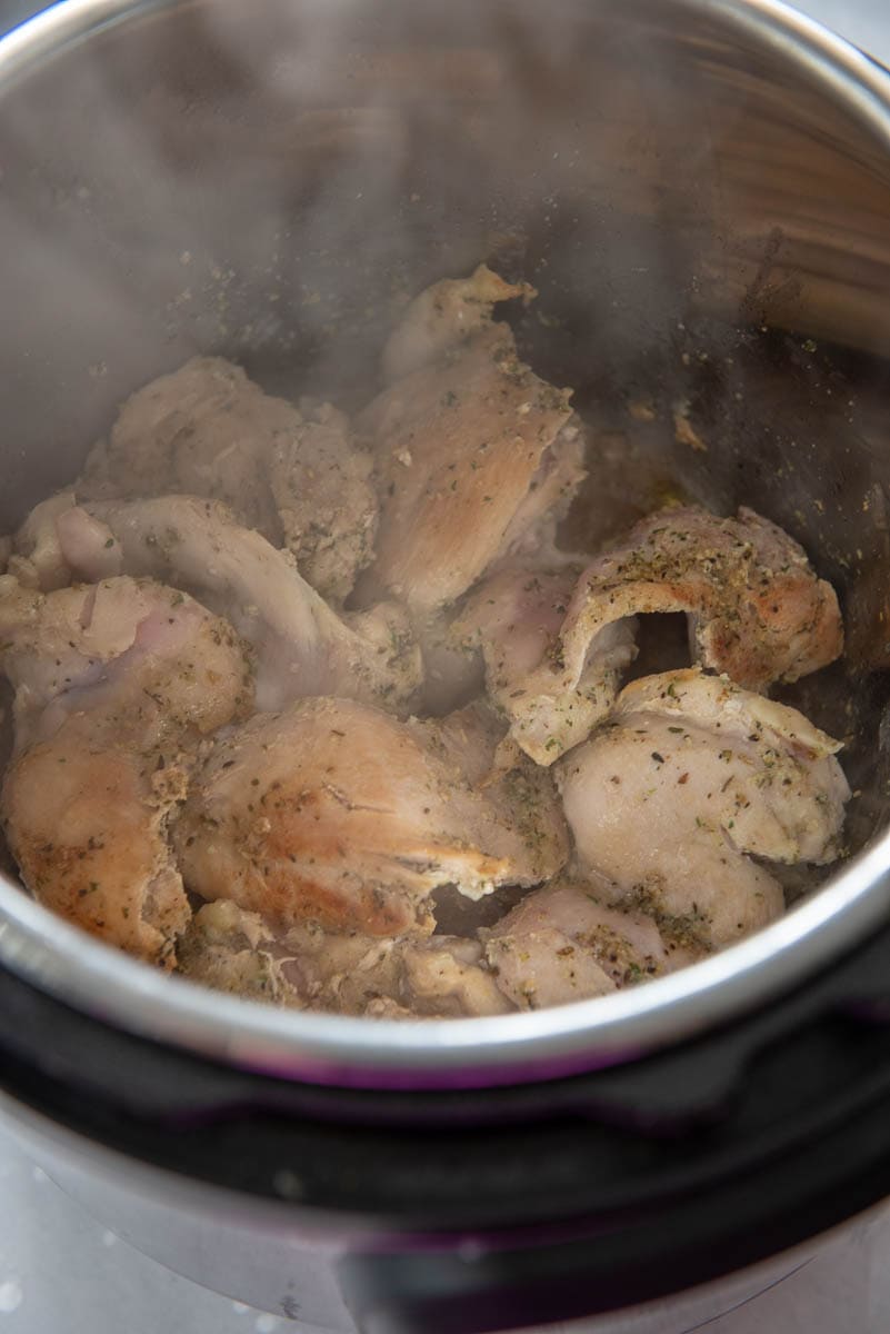chicken thighs being browned in Instant Pot