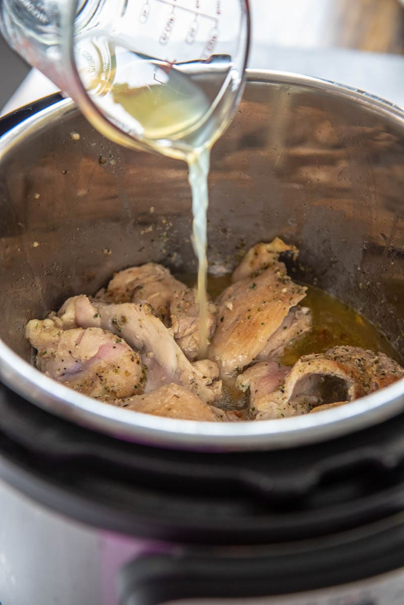 adding chicken broth to chicken thighs in instant pot