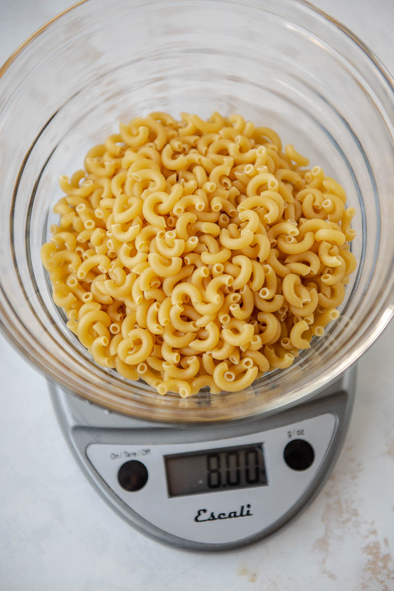 measuring noodles for Mac and cheese