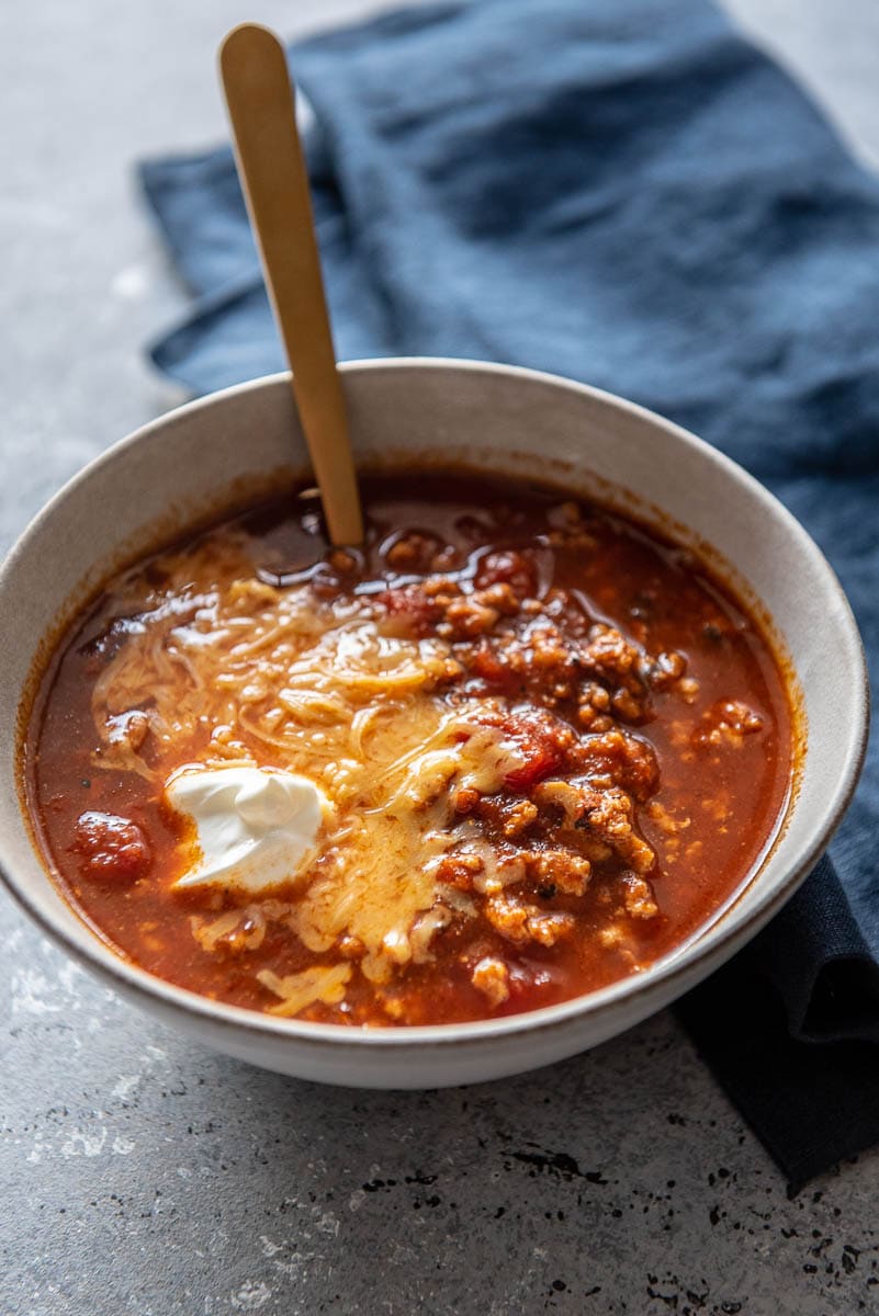 bowl of chili with cheese and sour cream