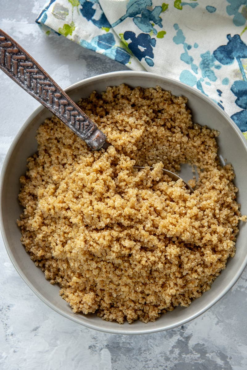 bowl with cooked quinoa and serving spoon
