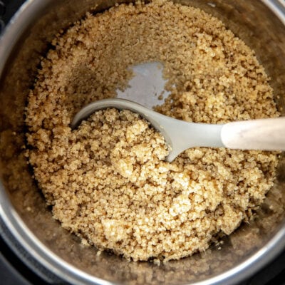 instant pot filled with cooked quinoa and serving spoon with wood handle