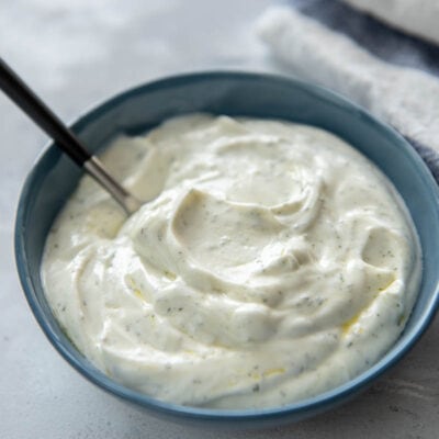 yogurt sauce with spoon in blue bowl