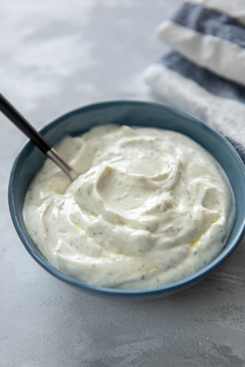 yogurt sauce with spoon in blue bowl