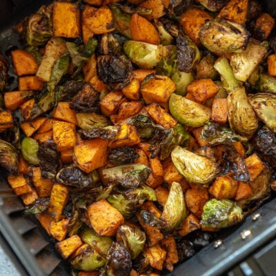 sweet potatoes and Brussels sprouts in air fryer basket