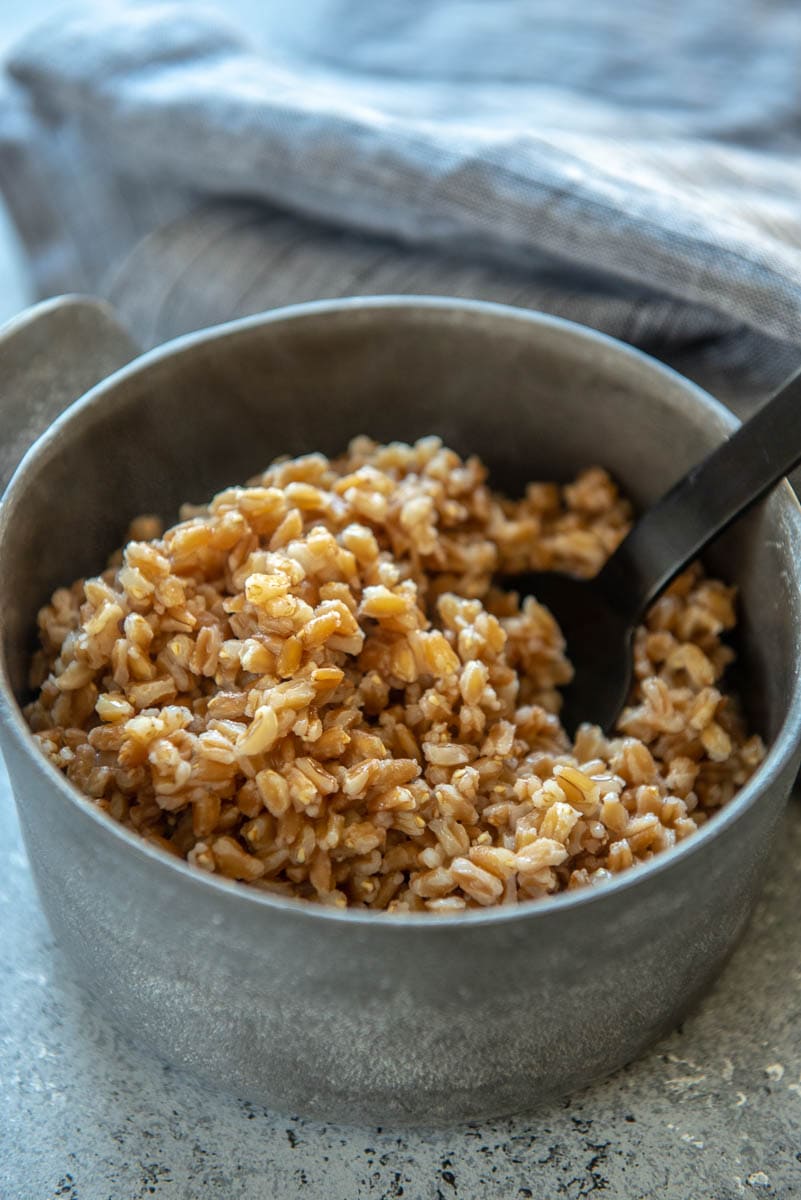 farro with black spoon in serving bowl