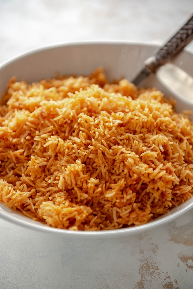Spanish rice with spoon in white bowl