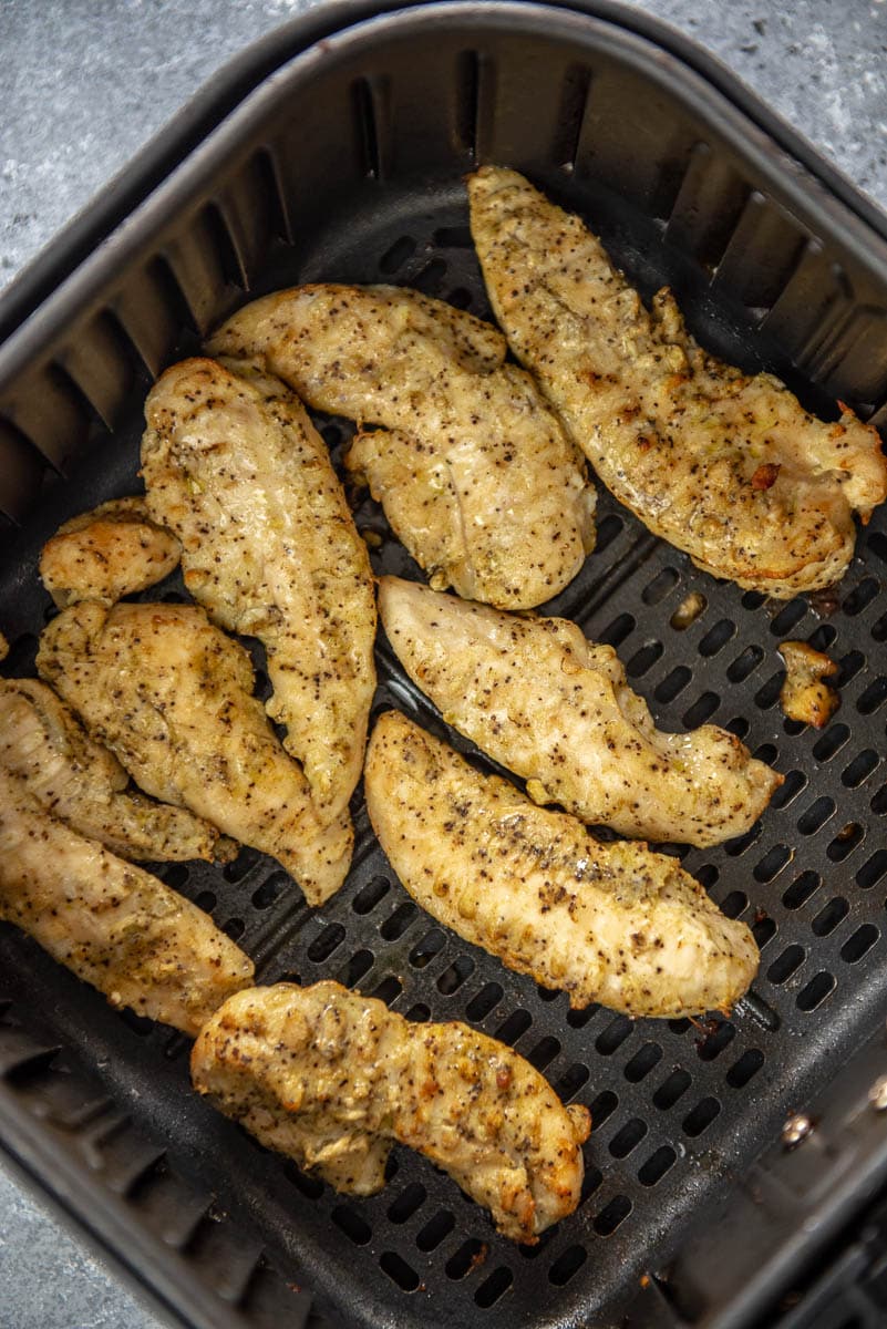 cooked chicken tenderloins in air fryer basket