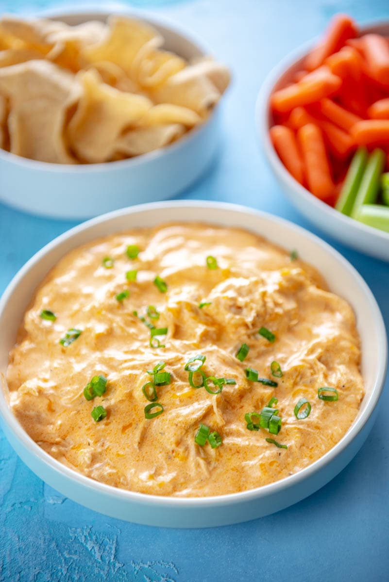 buffalo chicken dip with green onions in white bowl
