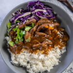 gray bowl with instant pot pepper steak rice and cabbage