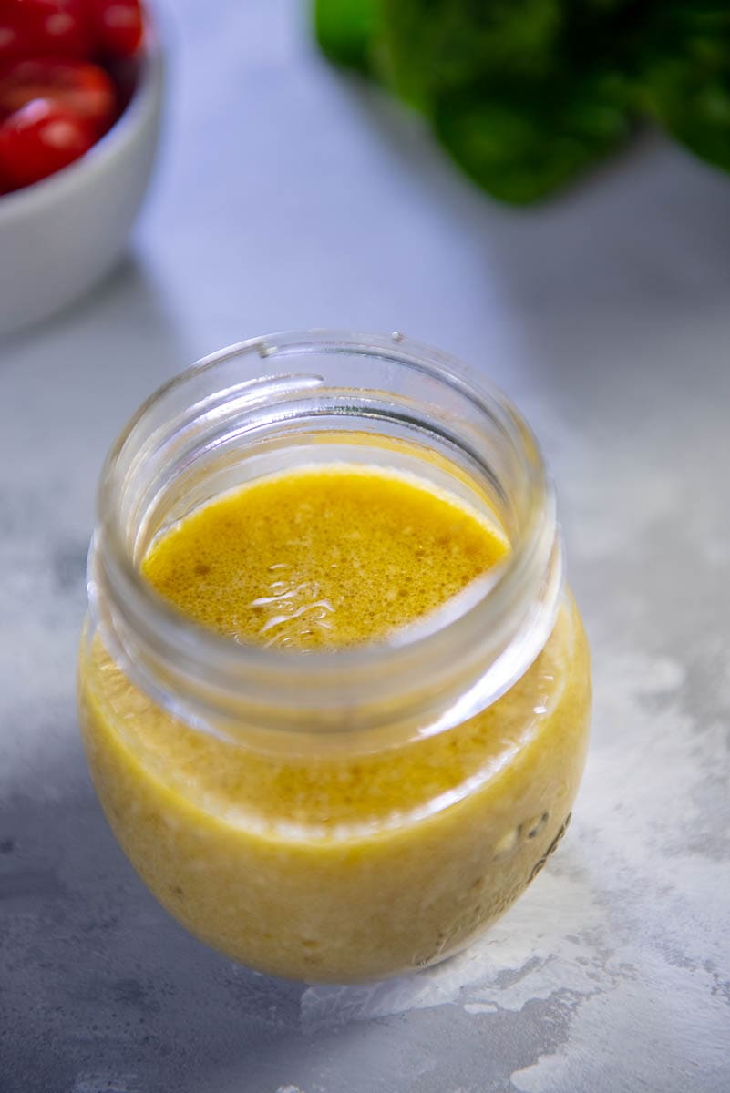 small glass jar with lemon vinaigrette