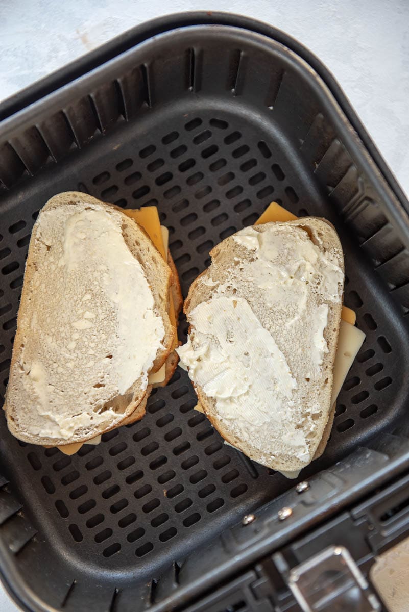 uncooked grilled cheese in air fryer basket