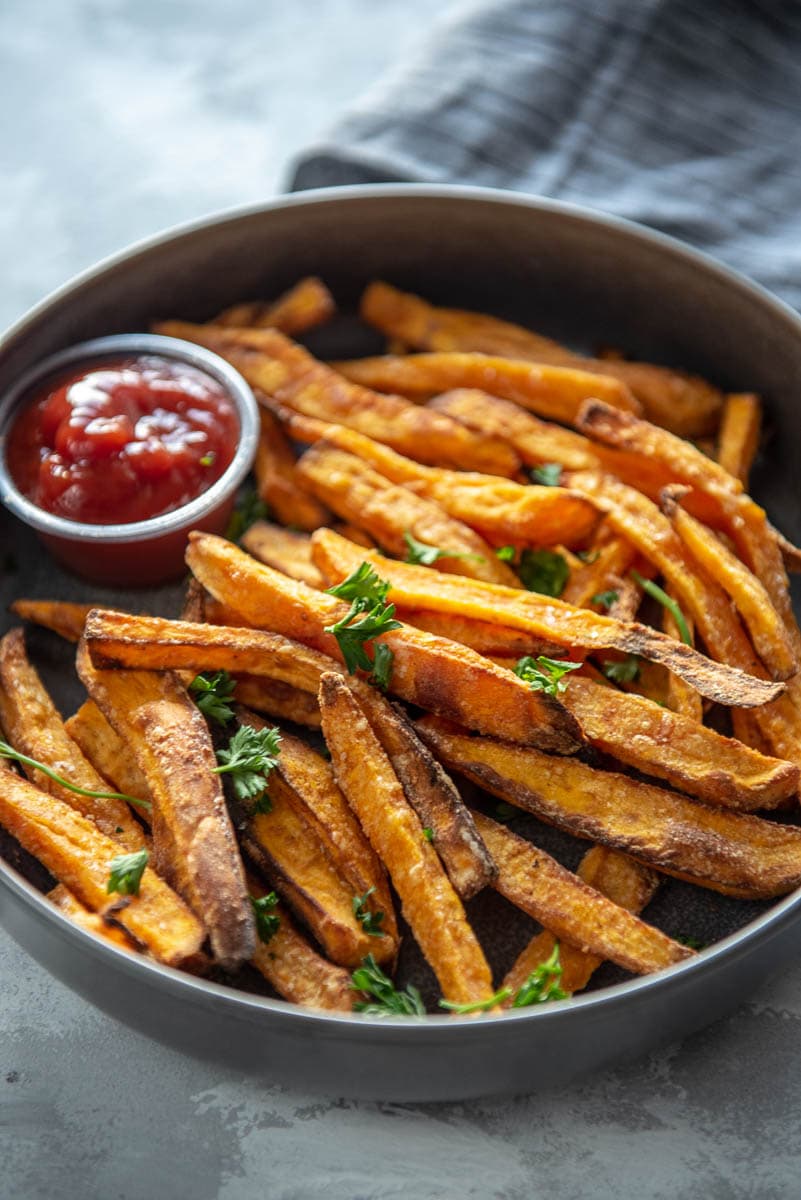 gray bowl filled with homemade sweet potato fries