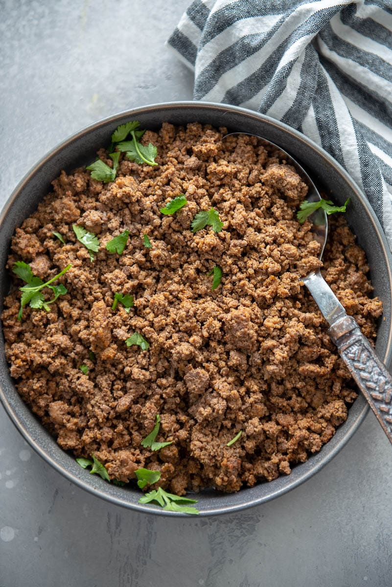 taco meat with serving spoon in gray serving bowl