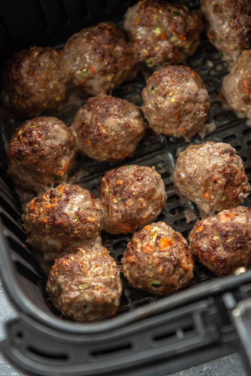 12 cooked meatballs in air fryer basket