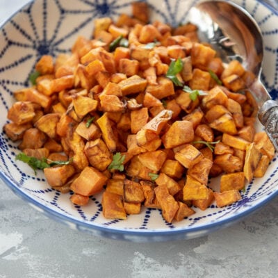 blue and white bowl filled with cubed air fried sweet potatoes