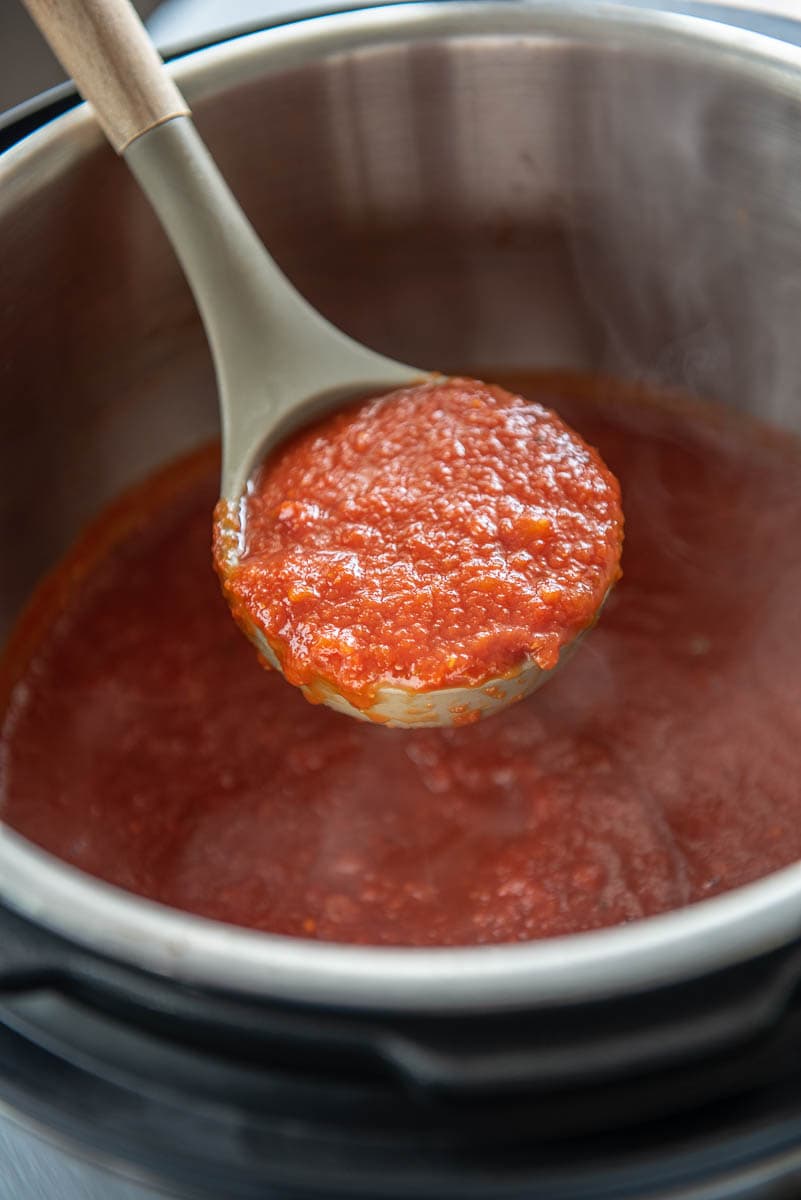 spaghetti sause on a spoon in an instant pot