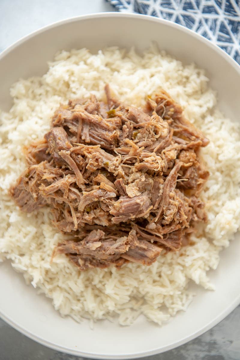 carnitas and rice on a white plate