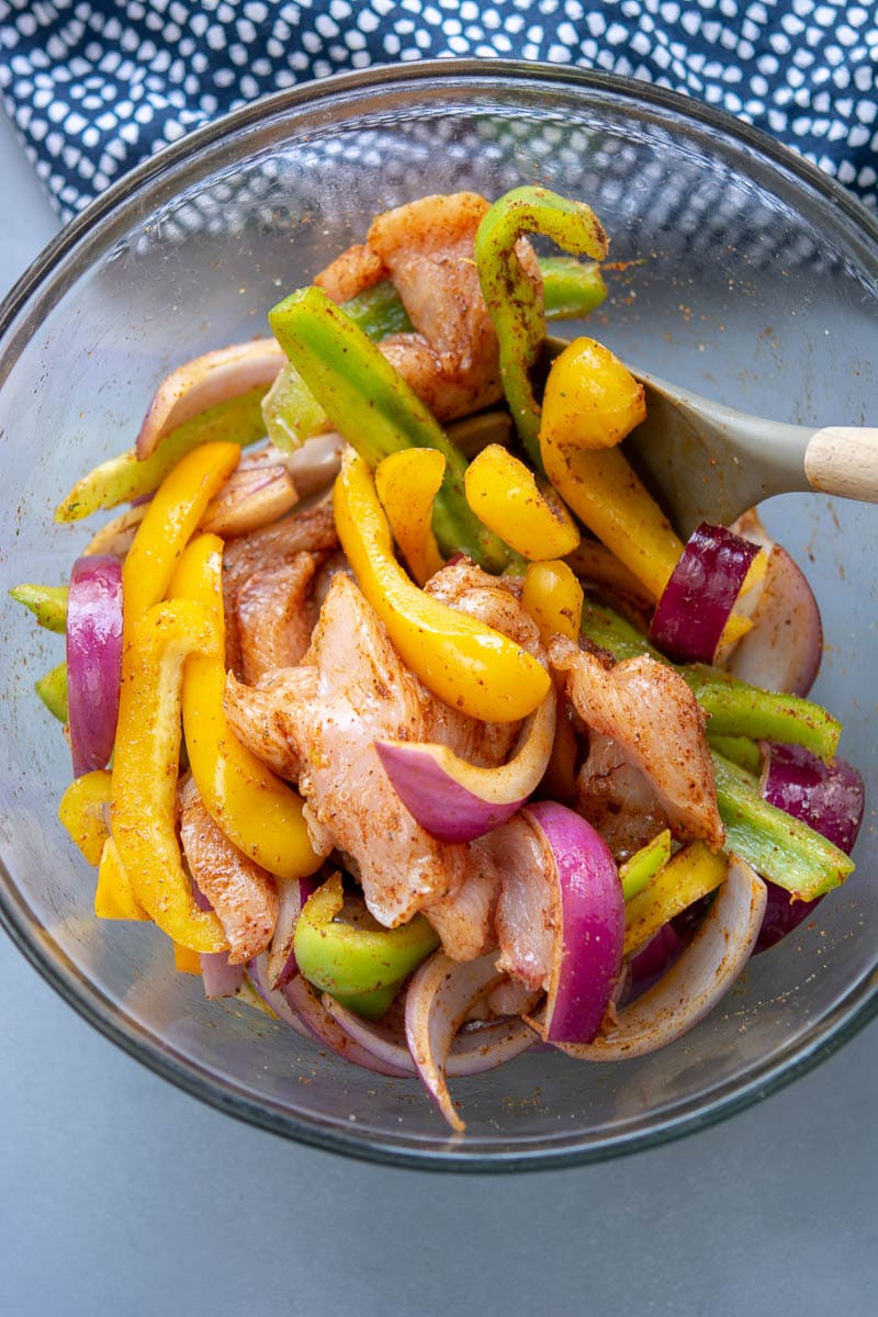 raw chicken and veggies for fajitas