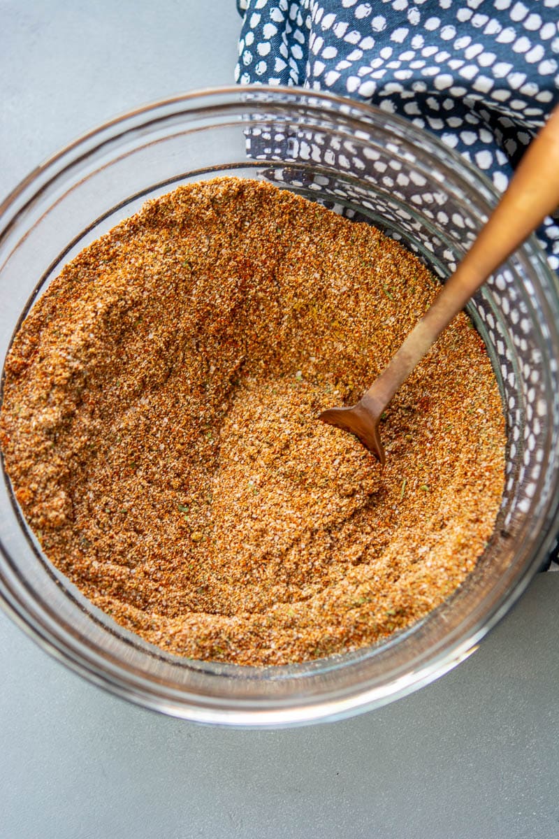 ingredients for homemade fajita seasoning mixed in a jar with a spoon