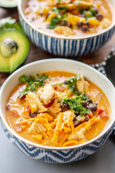 chicken fajita soup in a bowl with garnish
